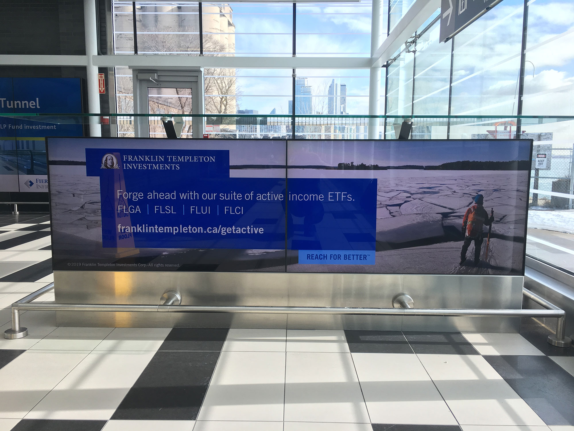 Active income ETF ad on a large-format digital display