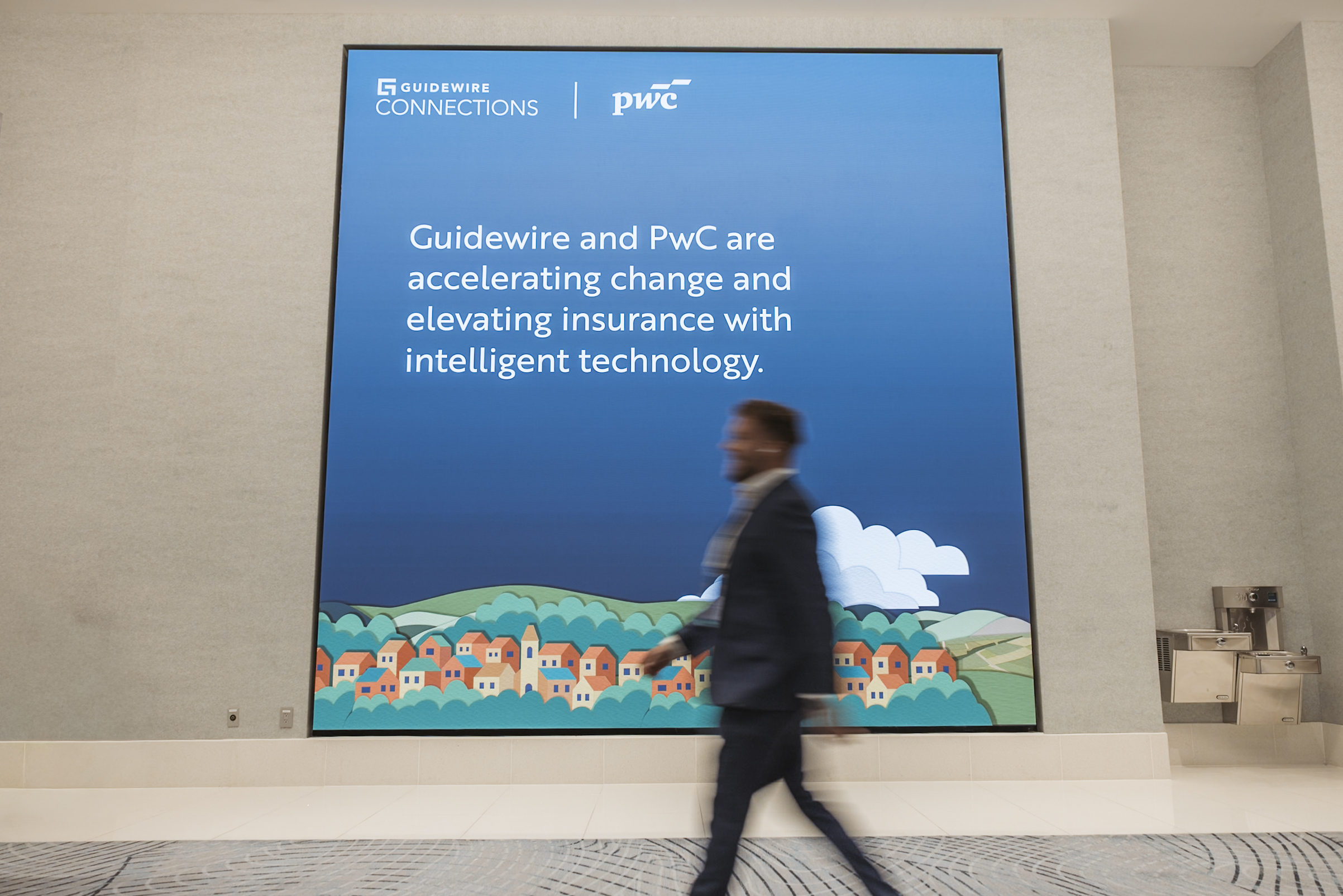 Attendee walking past environmental branding display