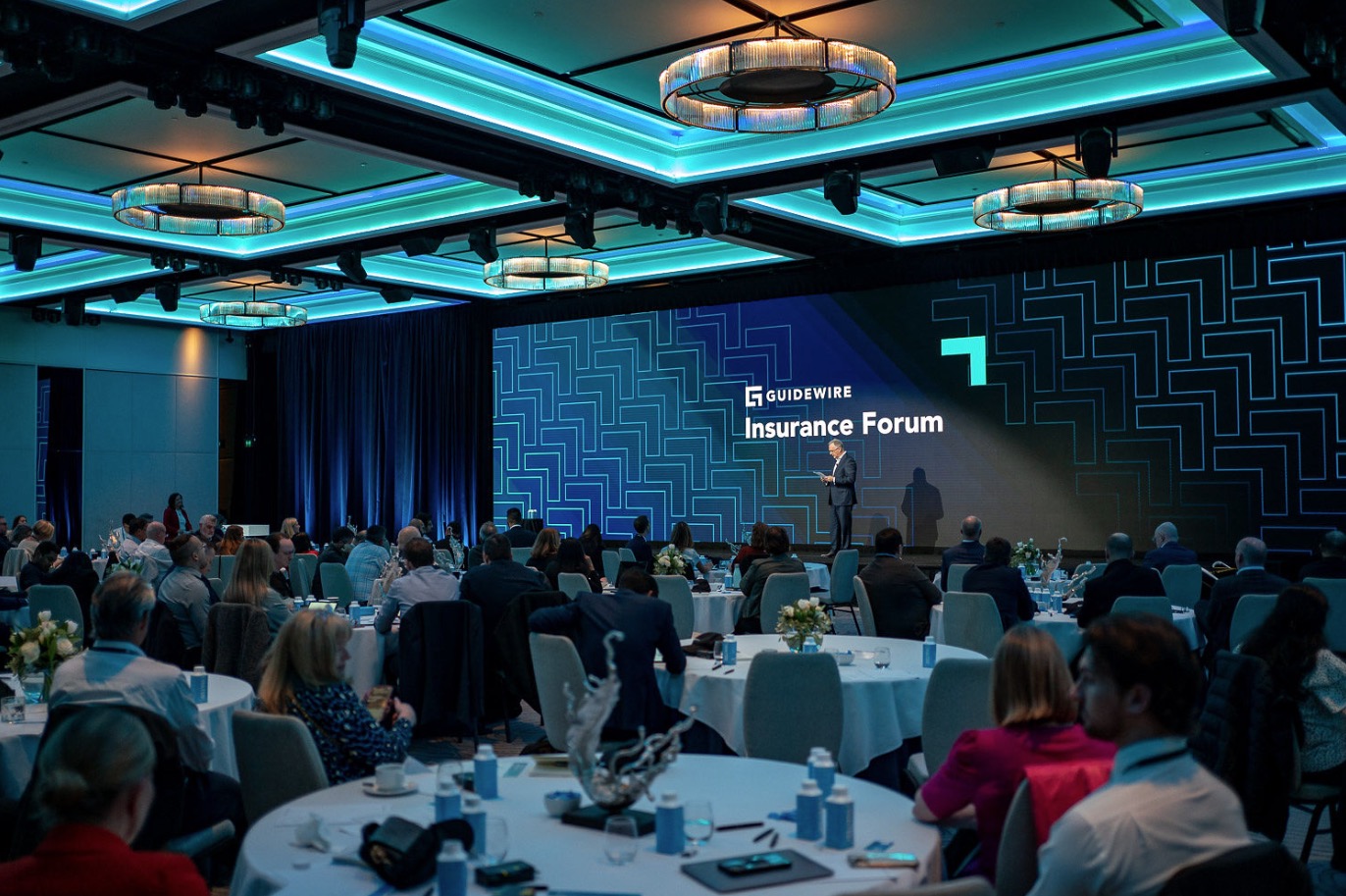 Guidewire Insurance Forum ballroom with teal environmental lighting